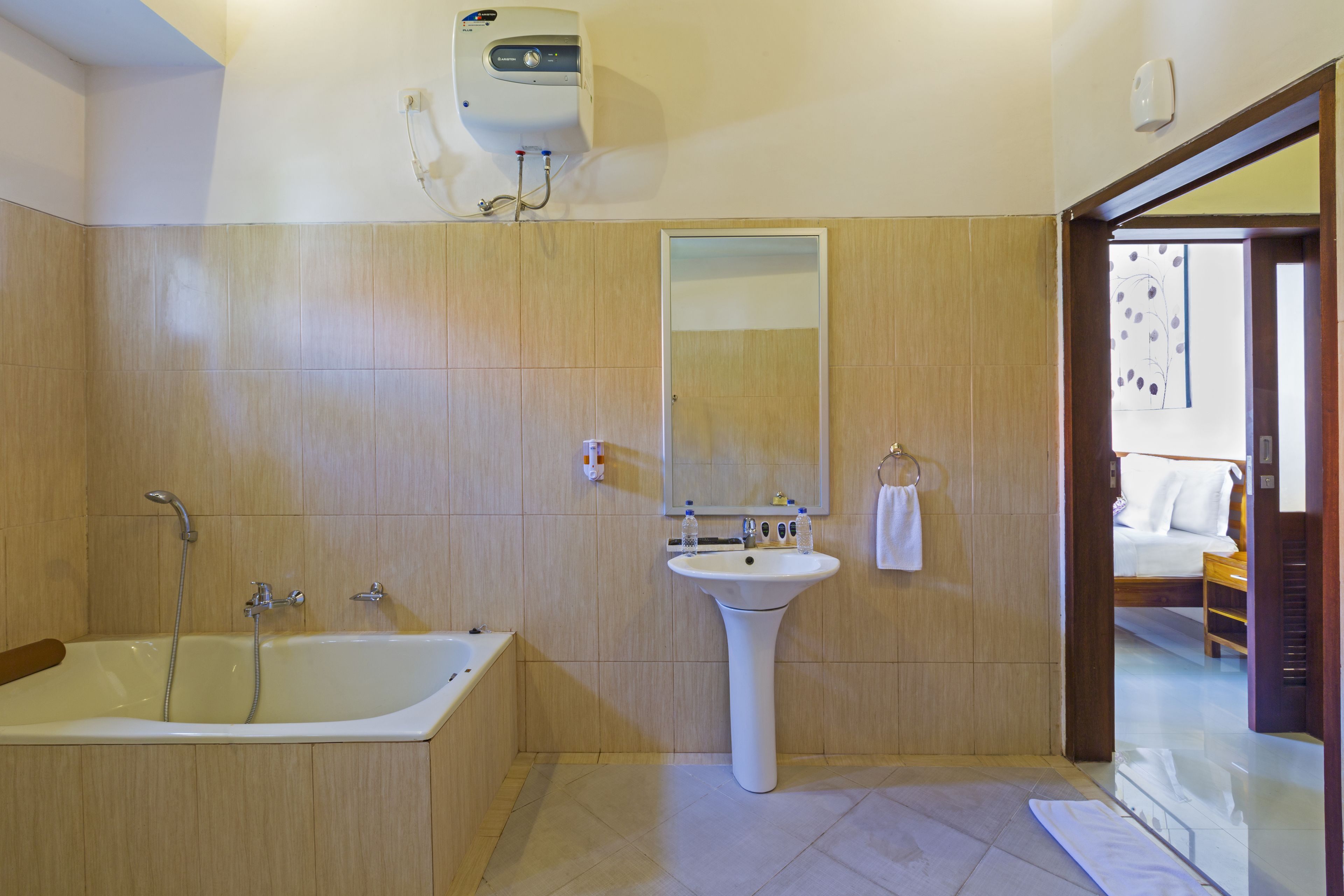 A modern bathroom with a bathtub, sink, and mirror.
