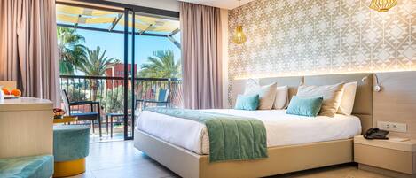A modern hotel room with a large bed, a balcony with a view, and a patterned wall.