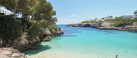 On the beach, white sand, sun loungers, beach umbrellas