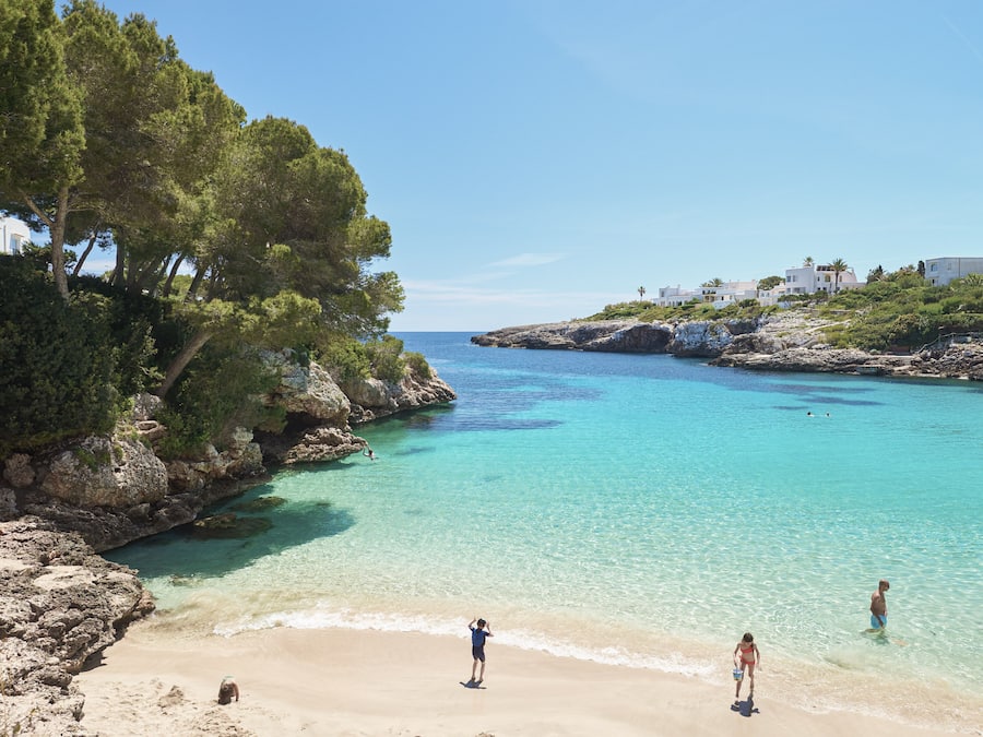 On the beach, white sand, sun loungers, beach umbrellas