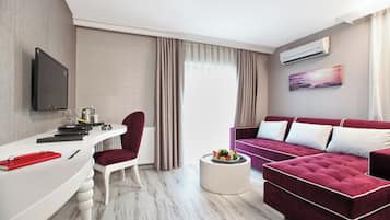 Suite (Jacuzzi) | Zona de estar | Una televisión LED