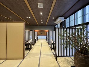 A hotel lobby with a central corridor, seating areas, and a large potted plant. - Mount View Hakone (Hakone)
