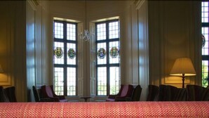 A formal dining room with a long table, two chairs, and two lamps. - Madingley Hall (Cambridge)