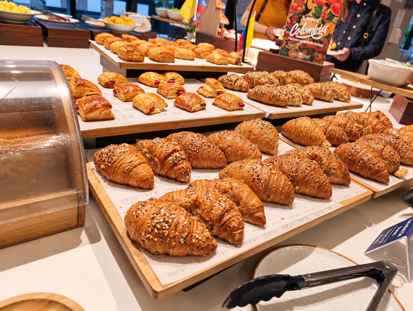 A buffet with various pastries and a display case.