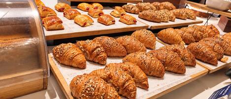 A buffet with various pastries and a display case.