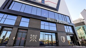 A hotel with a modern design, featuring large windows and a prominent sign for the hotel's football theme. - Hotel Football, Old Trafford, a Tribute Portfolio Hotel (Manchester)