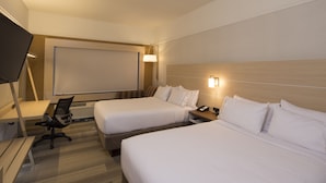 A hotel room with two beds, a desk, a chair, a TV, and a projector screen. - Holiday Inn Express & Suites Rochester Hill - Detroit Area by IHG (Rochester)