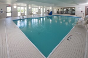 An indoor swimming pool with clear water, marked depth lines, and a lifeguard chair. - Holiday Inn Express & Suites Rochester Hill - Detroit Area by IHG (Rochester)