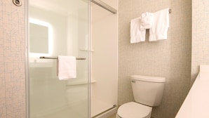 A modern bathroom with a glass-enclosed shower, a toilet, and a towel rack with two towels. - Holiday Inn Express & Suites Rochester Hill - Detroit Area by IHG (Rochester)
