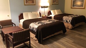 A hotel room with two beds, a desk, a chair, and a lamp. - Budget Inn Express (Sheridan)