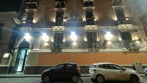 A hotel with a classic facade, multiple balconies, and a sign indicating it is a hotel. - Hotel Sangiuliano (Catania)
