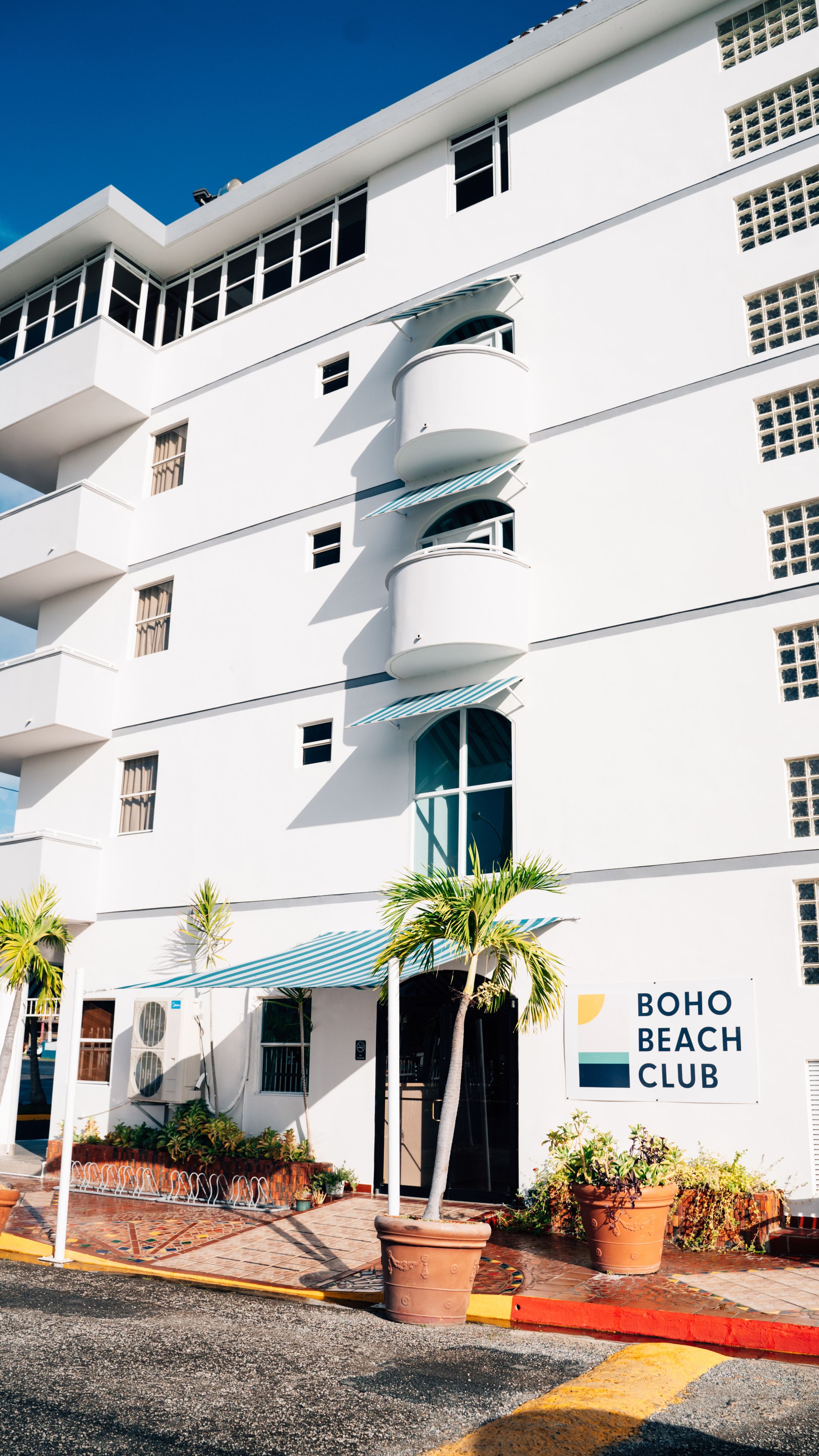A multi-story building with a sign reading "BOHO BEACH CLUB".