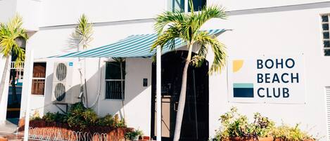 A multi-story building with a sign reading "BOHO BEACH CLUB".