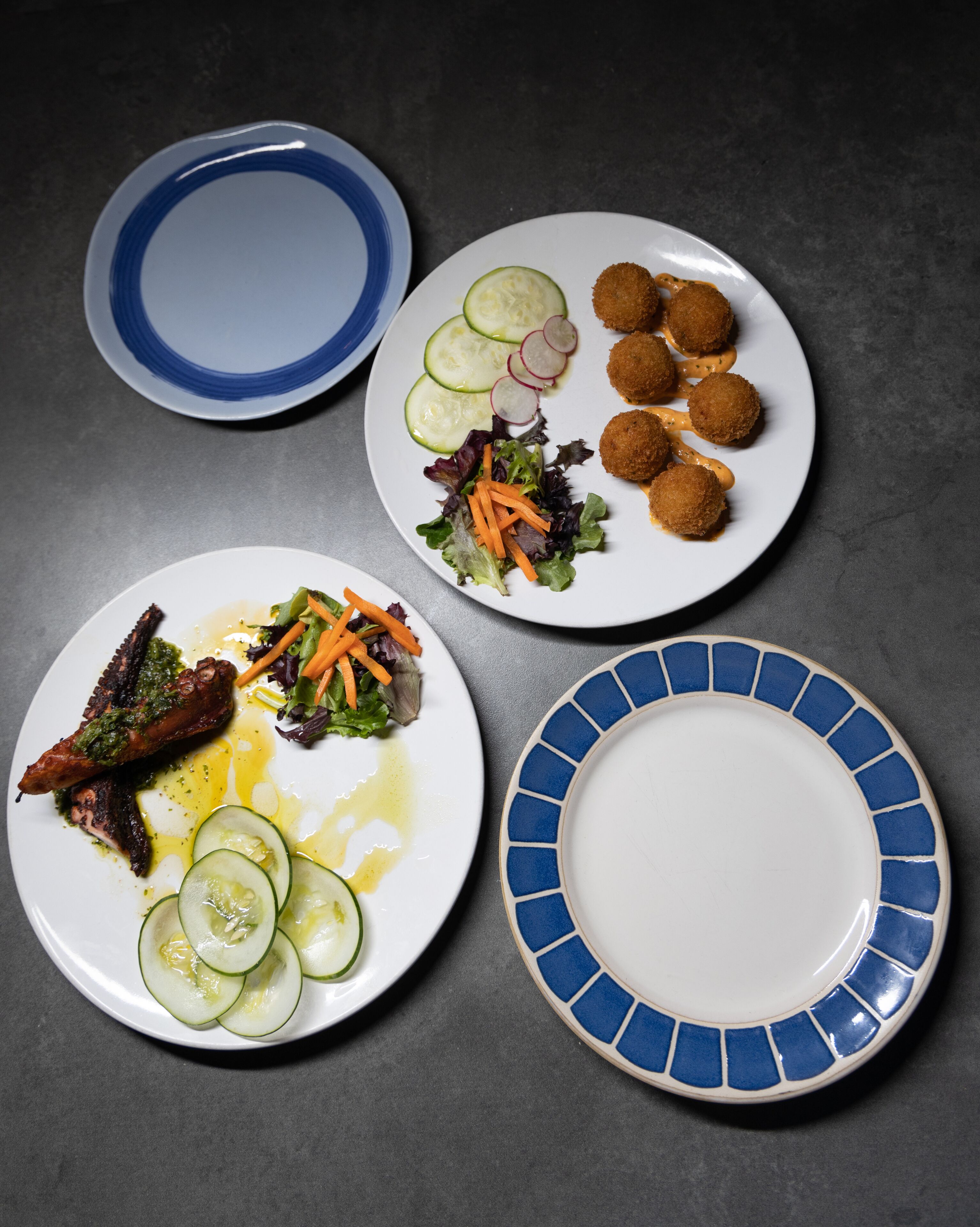 Three plates of food on a table.