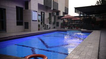 Outdoor pool, open 7:00 AM to 7:00 PM, pool umbrellas