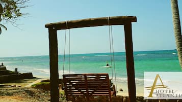 On the beach, white sand, sun-loungers, beach towels