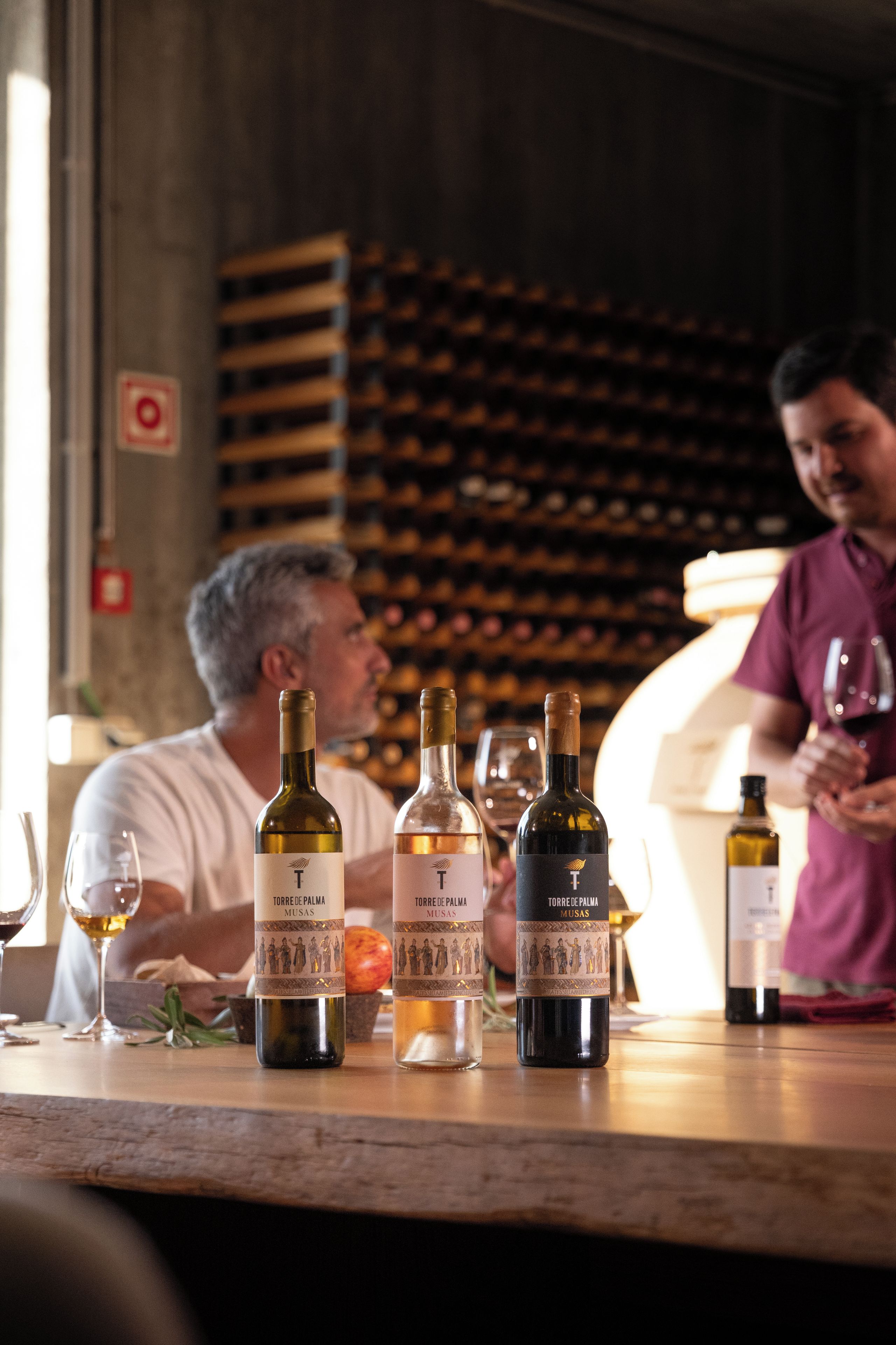 A wine tasting event with bottles of wine on a table.