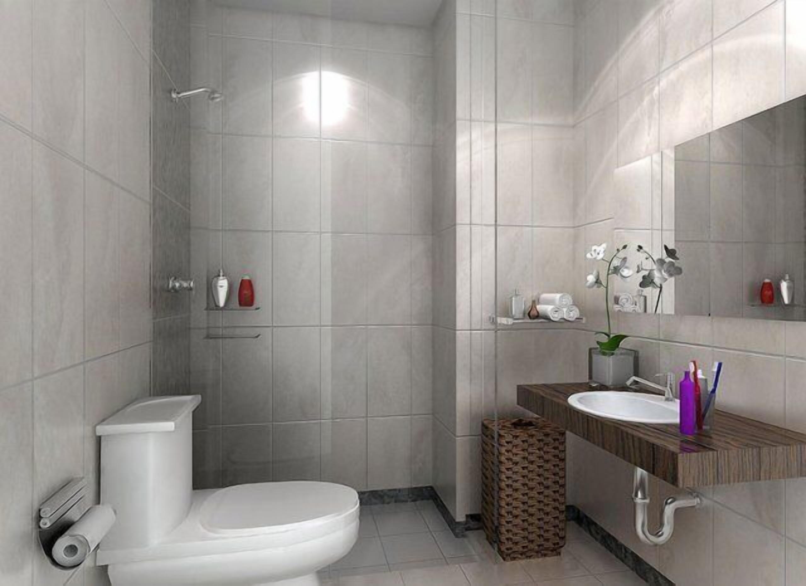 A modern bathroom with a toilet, shower, and sink.