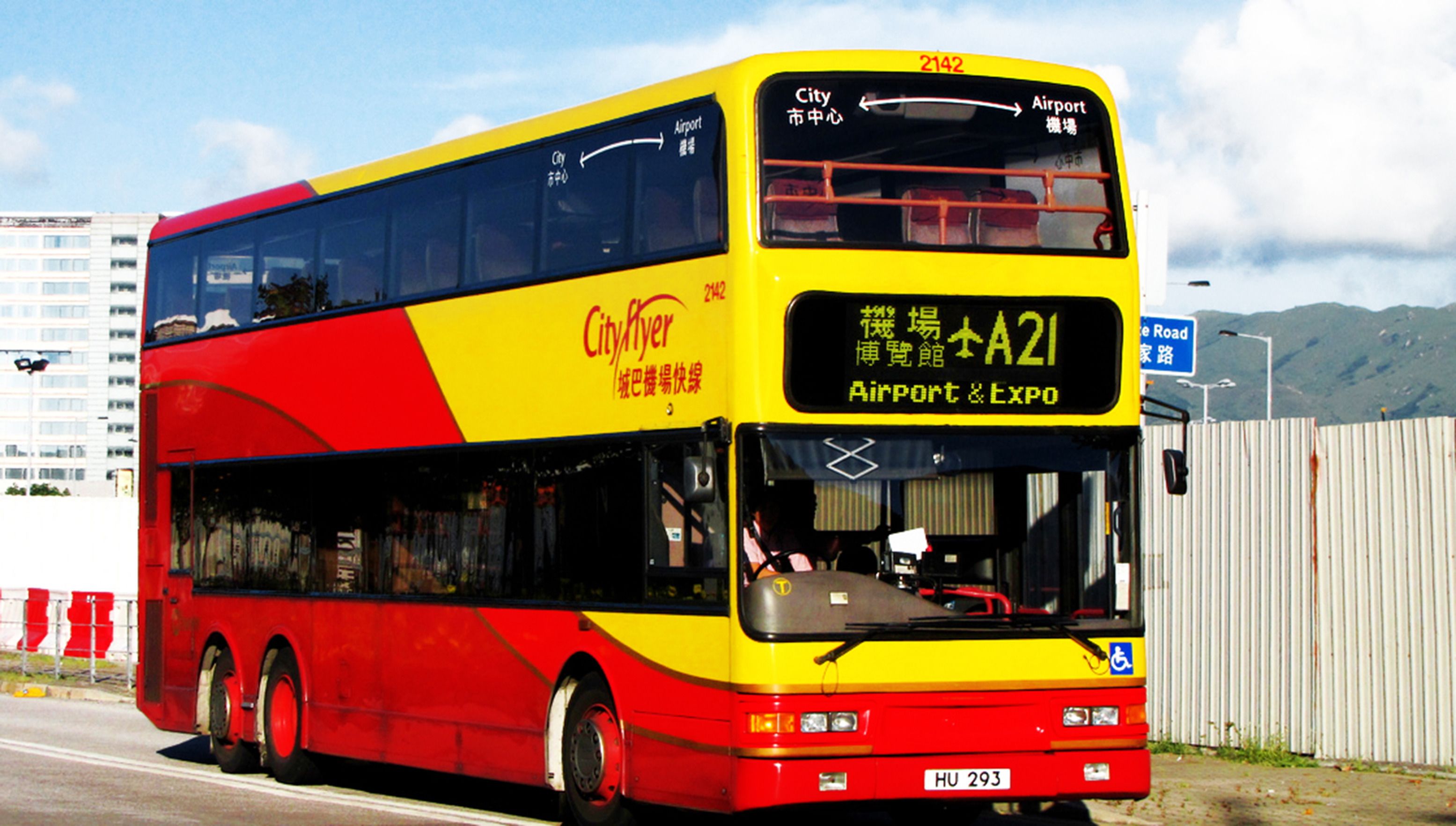 A double-decker bus with "City Flyer" branding, heading towards the airport and Expo.
