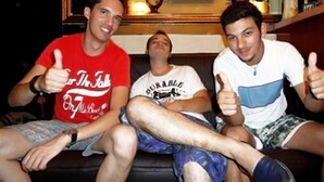 Three people sitting on a couch with a decorative item and an air conditioner in the background. - Germany Hostel (Kowloon)