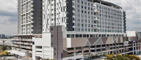 A modern hotel with a prominent 'Citadines' sign, multiple floors, and a parking structure.