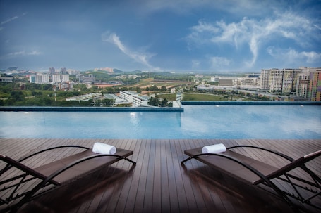 Una piscina al aire libre, camas de piscina gratis, sombrillas