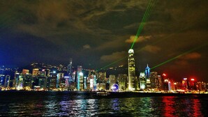 A nighttime city skyline with illuminated buildings and a prominent tower. - Manila Hotel - Hostel (Kowloon)