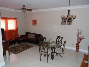 Townhome | Living area | 46-inch LED TV with cable channels, TV, books - Taste of Paradise (Nassau)