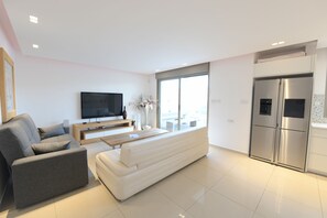 Deluxe Apartment, 3 Bedrooms, Private Pool, Sea View | Living area | Flat-screen TV, fireplace
