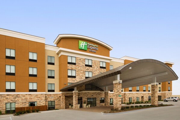 A Holiday Inn Express & Suites building with a modern design, featuring a brick facade, multiple windows, and a covered entrance area. - Holiday Inn Express & Suites Waco South by IHG (Waco)