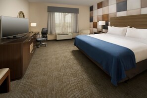 A hotel room with a large bed, a television, a desk, and a chair. - Holiday Inn Express & Suites Waco South by IHG (Waco)