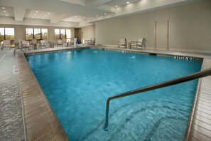 An indoor swimming pool with clear water, surrounded by lounge chairs and a tiled deck. - Holiday Inn Express & Suites Waco South by IHG (Waco)