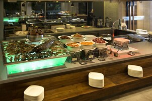 A buffet with various dishes and seafood displayed on a counter.