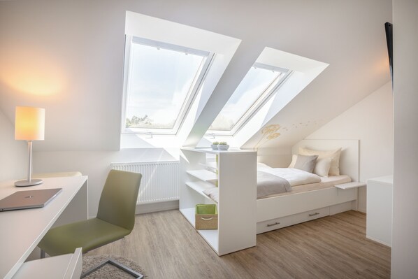 A modern bedroom with skylights, a desk, and a comfortable bed. - Candlewood Suites Furth by IHG (Fuerth)