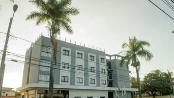 A multi-story hotel with a modern design, featuring a flat roof and a symmetrical facade.