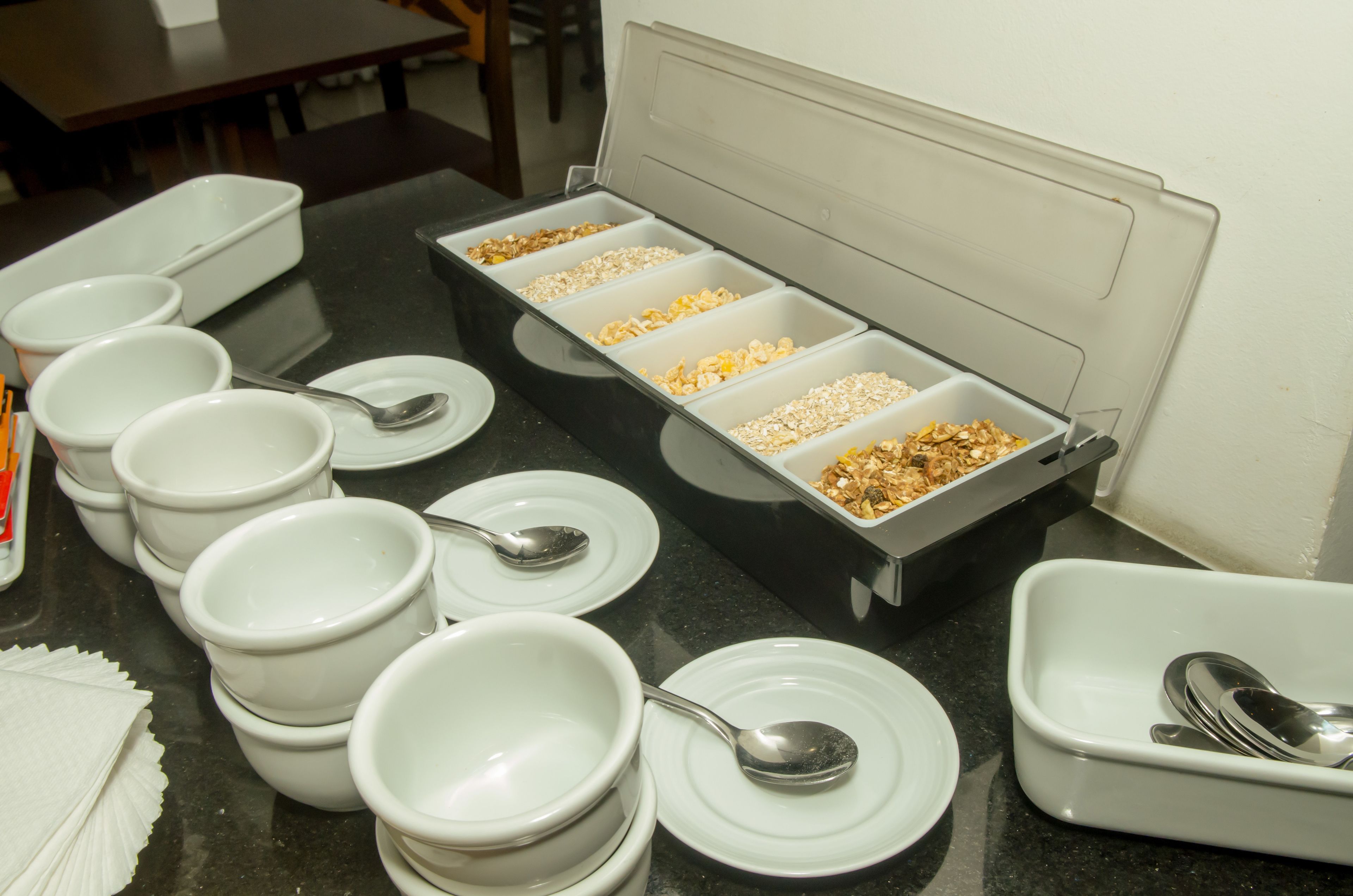 A buffet setup with multiple bowls and trays of food.