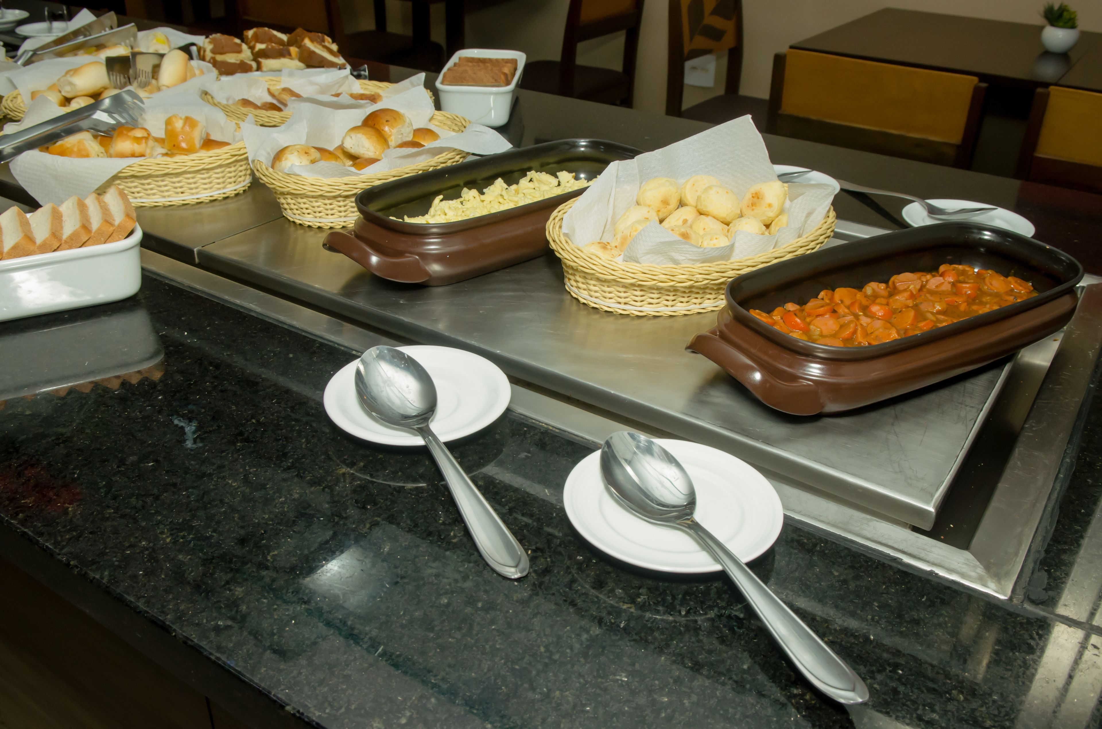 A buffet with various food items and serving utensils.