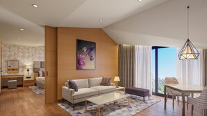 A modern living room with a sofa, coffee table, and dining area. - Vivanta New Delhi, Dwarka (New Delhi)