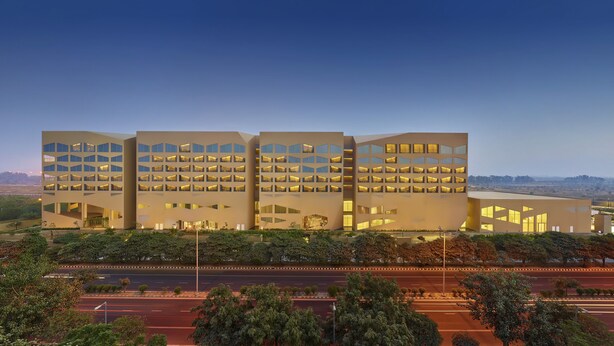 A modern building with multiple floors, large windows, and a flat roof. - Vivanta New Delhi, Dwarka (New Delhi)