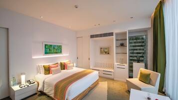 A modern hotel room with a large bed, bedside tables, a desk, and a chair.
