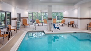 A pool area with chairs and a changing room.
