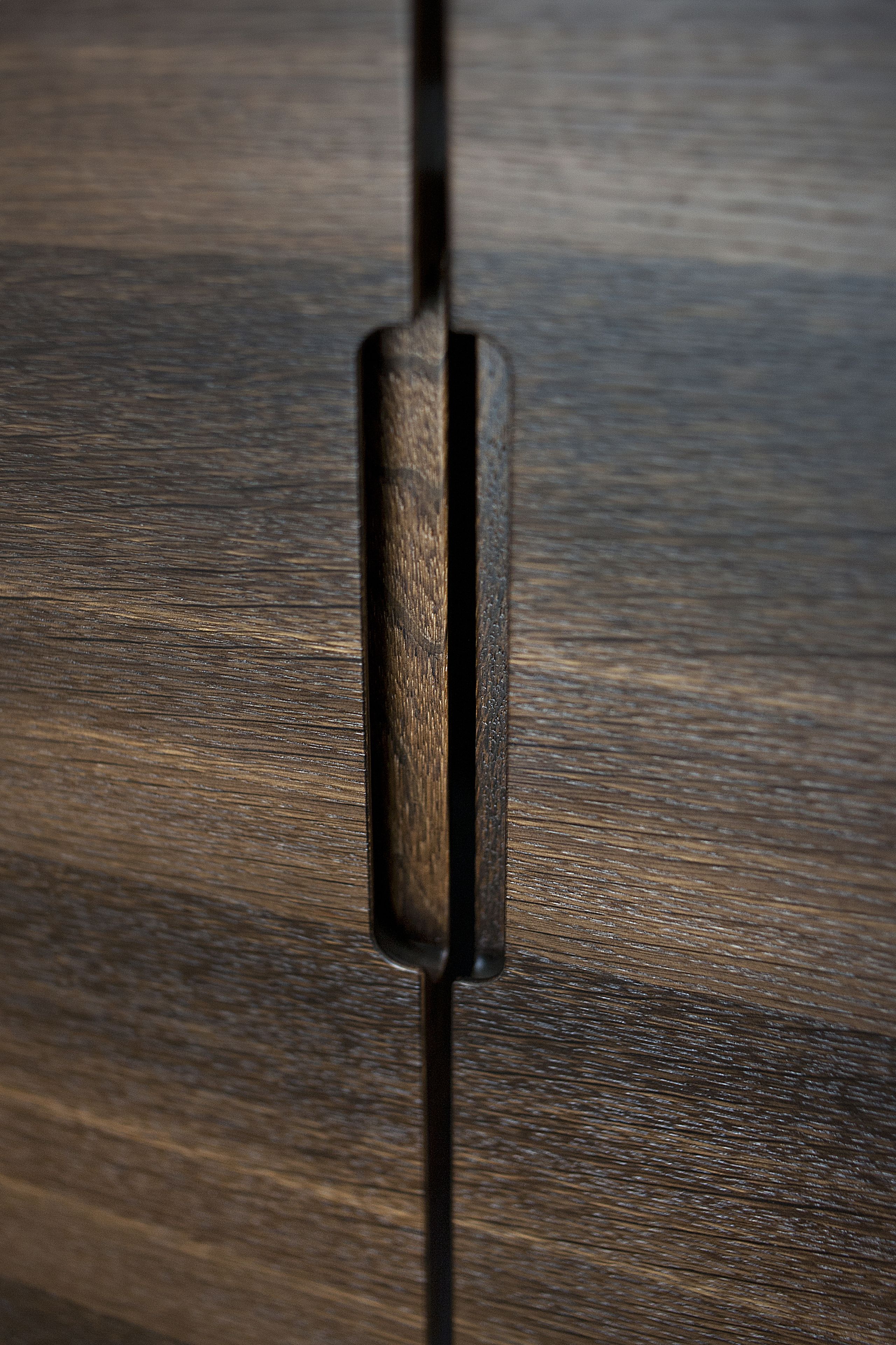 A close-up of a wooden surface with a vertical groove.