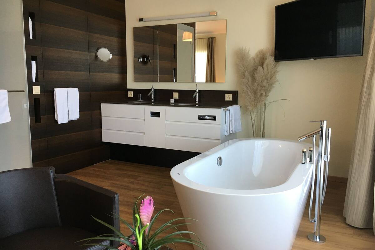 junior double room, bathtub, lake view | premium bedding, in-room safe, individually decorated, desk