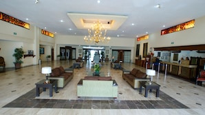 A spacious lobby with a chandelier, sofas, and a reception desk. - Hotel Real de Minas San Luis Potosi (San Luis Potosi)