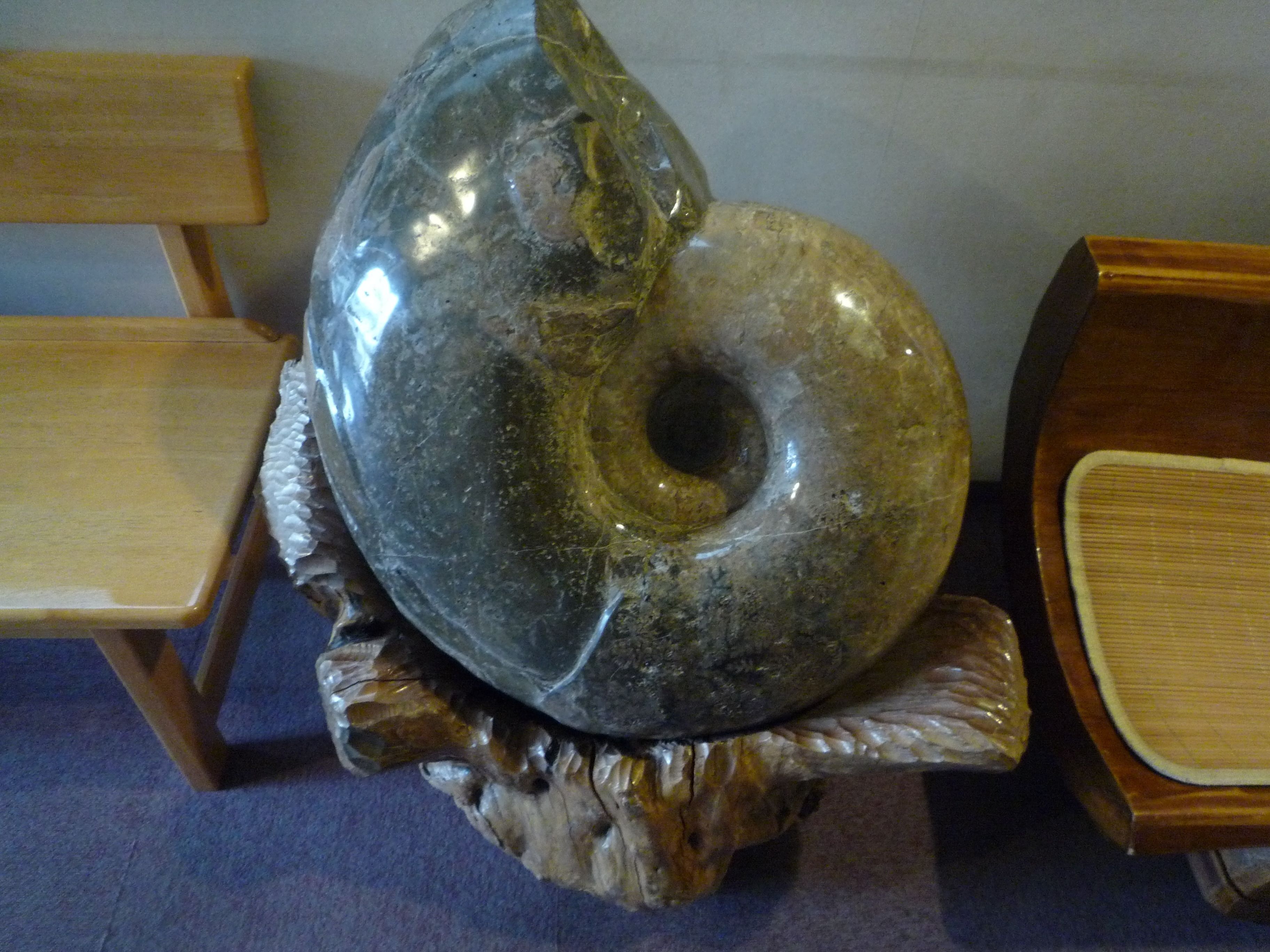 A large, polished stone sculpture on a wooden stand.