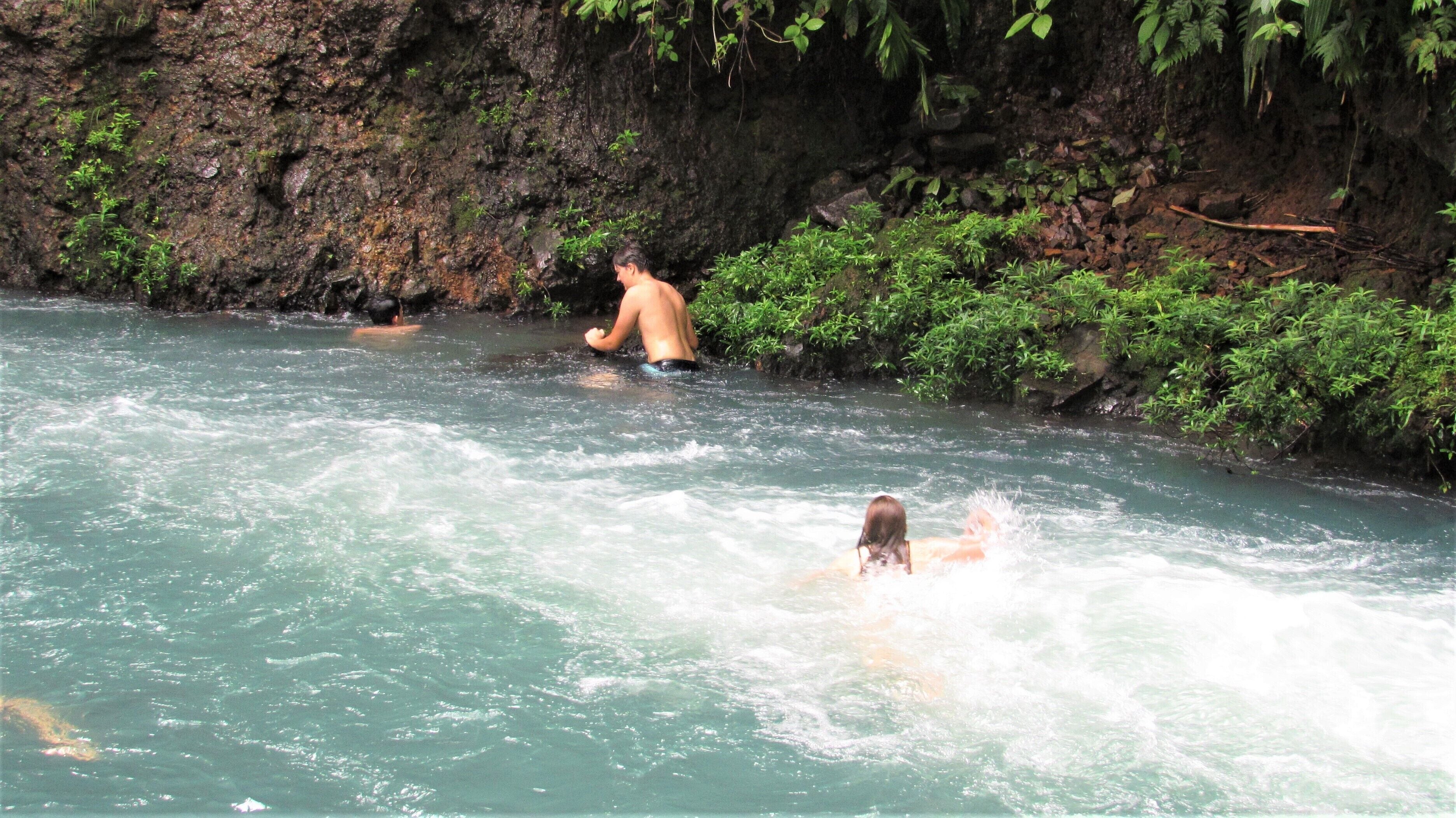 A natural water body with rocky surroundings and vegetation.