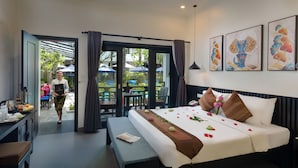 A hotel room with a bed, a bench, and a table with a tray of food. - Khmer Mansion Boutique Hotel (Siem Reap)
