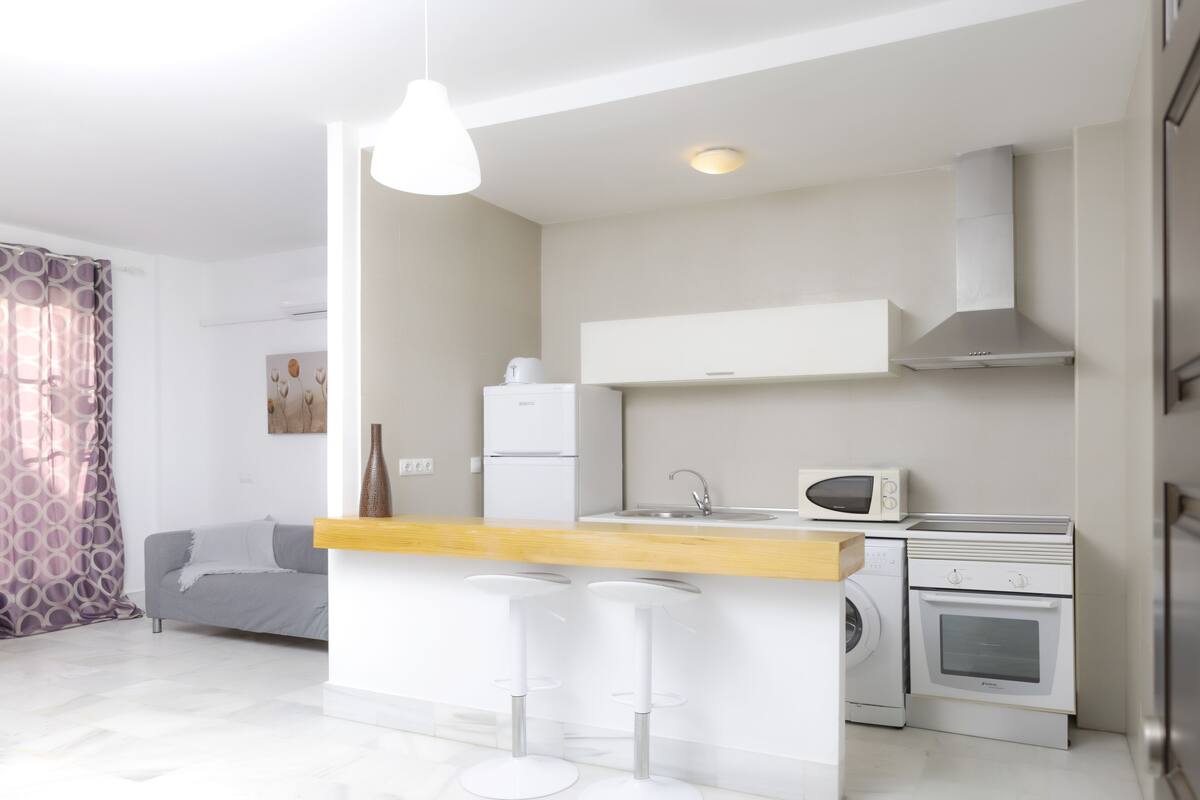 A modern kitchen with a central island, built-in appliances, and a minimalist design.