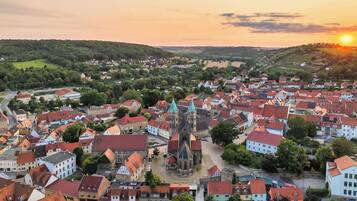 A town with historic buildings, a prominent church, and a river.