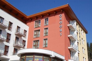 A multi-story building with balconies and a sign reading "CROCUS". - Hotel Crocus (Štrba)